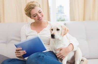 Frau mit Welpen auf dem Sofa